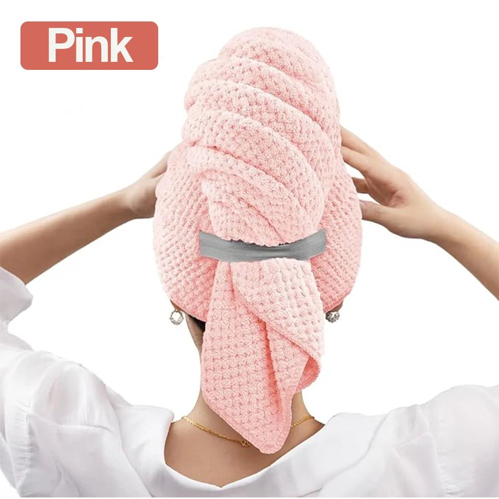 Pink hair towel being held by a person with a white background